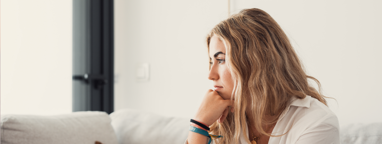 young woman considering her options for her unplanned pregnancy - parenting, abortion, or adoption