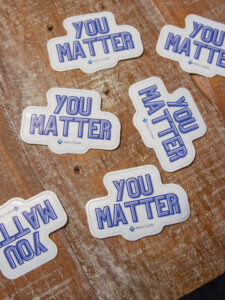 Alpha Center stickers that say "you matter"